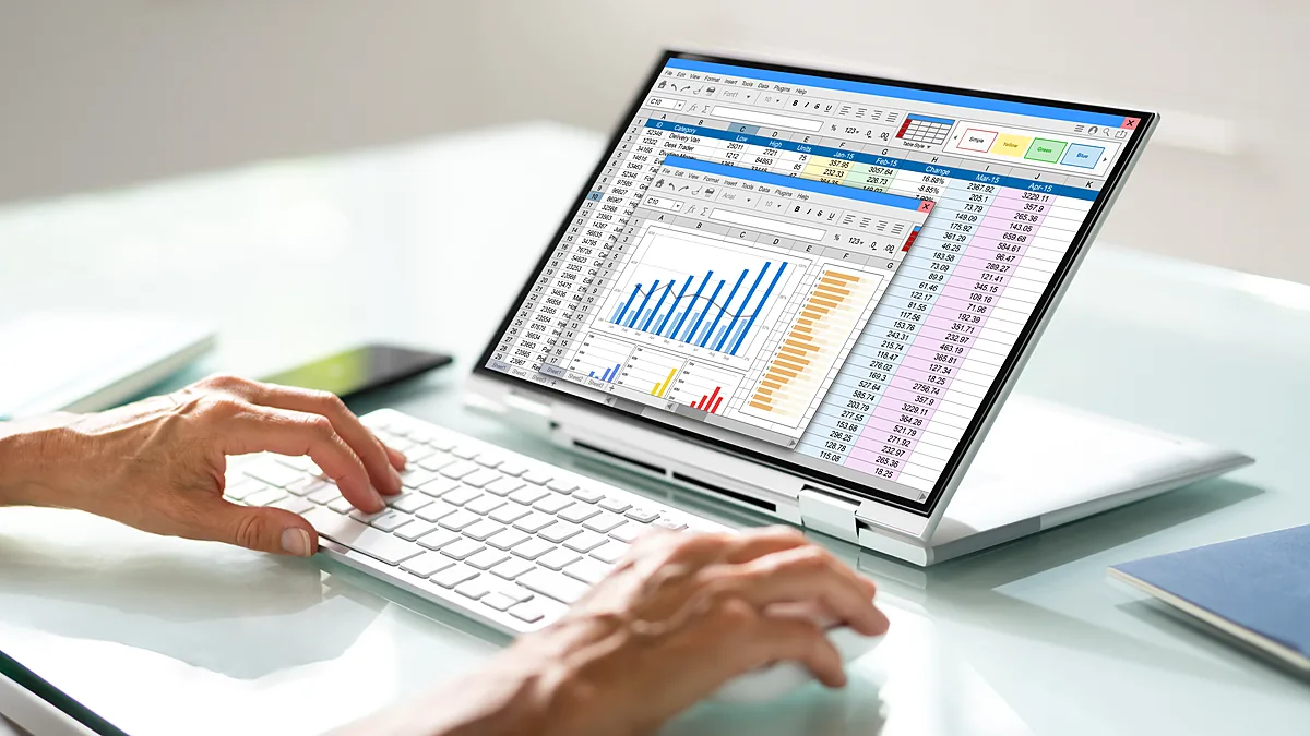 Analyst reviewing casting cost per kg charts and costing sheets on a laptop